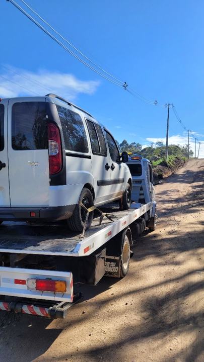 Fiat Doblò branco no guincho em uma estrada de terra
